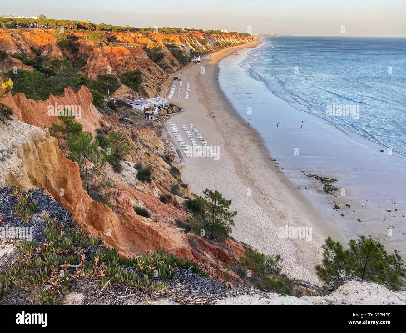Golden hour colors on an ocean beach with sandstone rock formations in Algarve, Portugal. - Smartphone Captured Stock Image