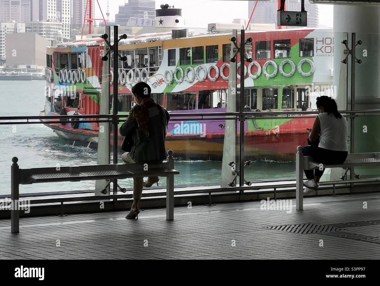 Passengers waiting for the Star Ferry in Hong Kong. Stock Photo