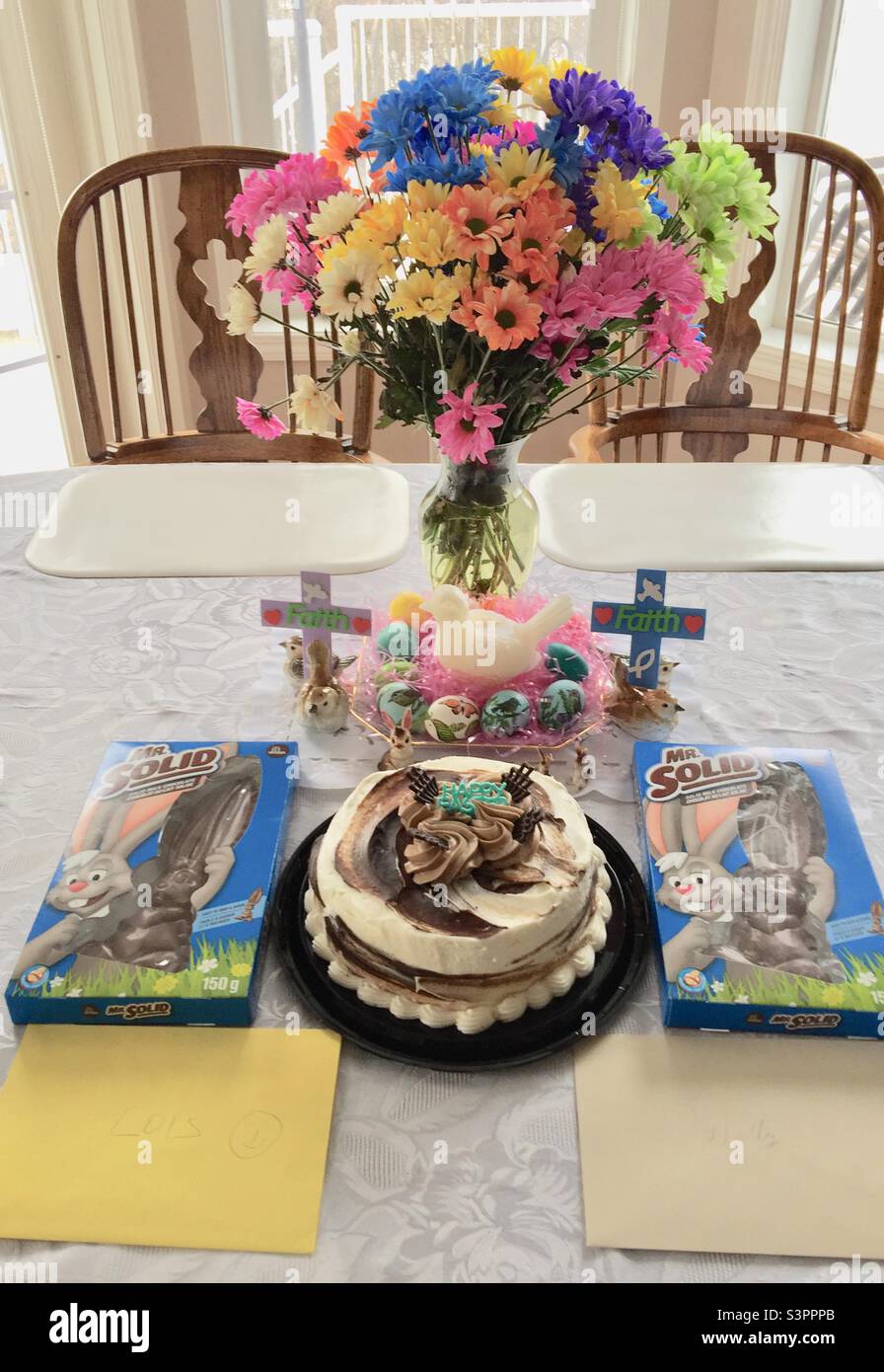 Easter celebration, cake, flowers, chocolate rabbits, greeting cards, decorations Stock Photo