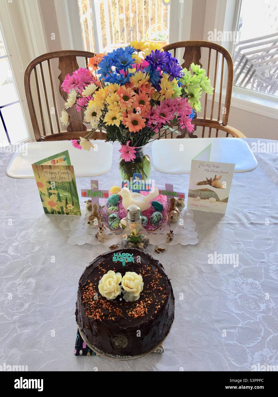 Easter celebration, cake, flowers, chocolate rabbits, greeting cards, decorations Stock Photo