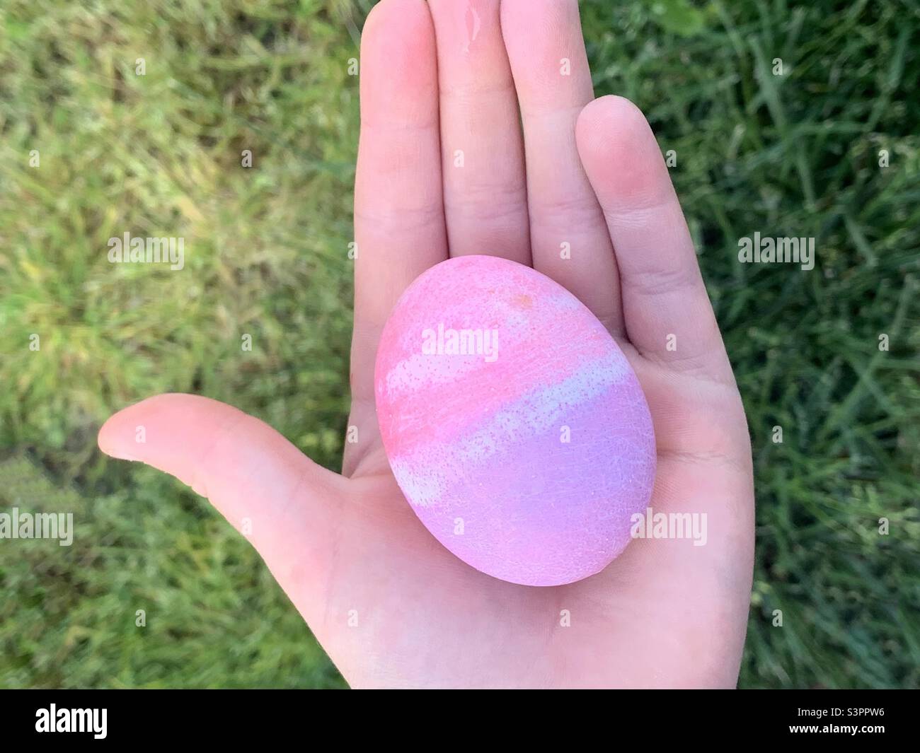 Child holding colorful Easter egg Stock Photo