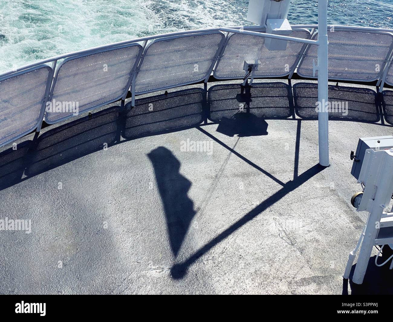 Shadow of a flag on the deck of a ferry. Stock Photo