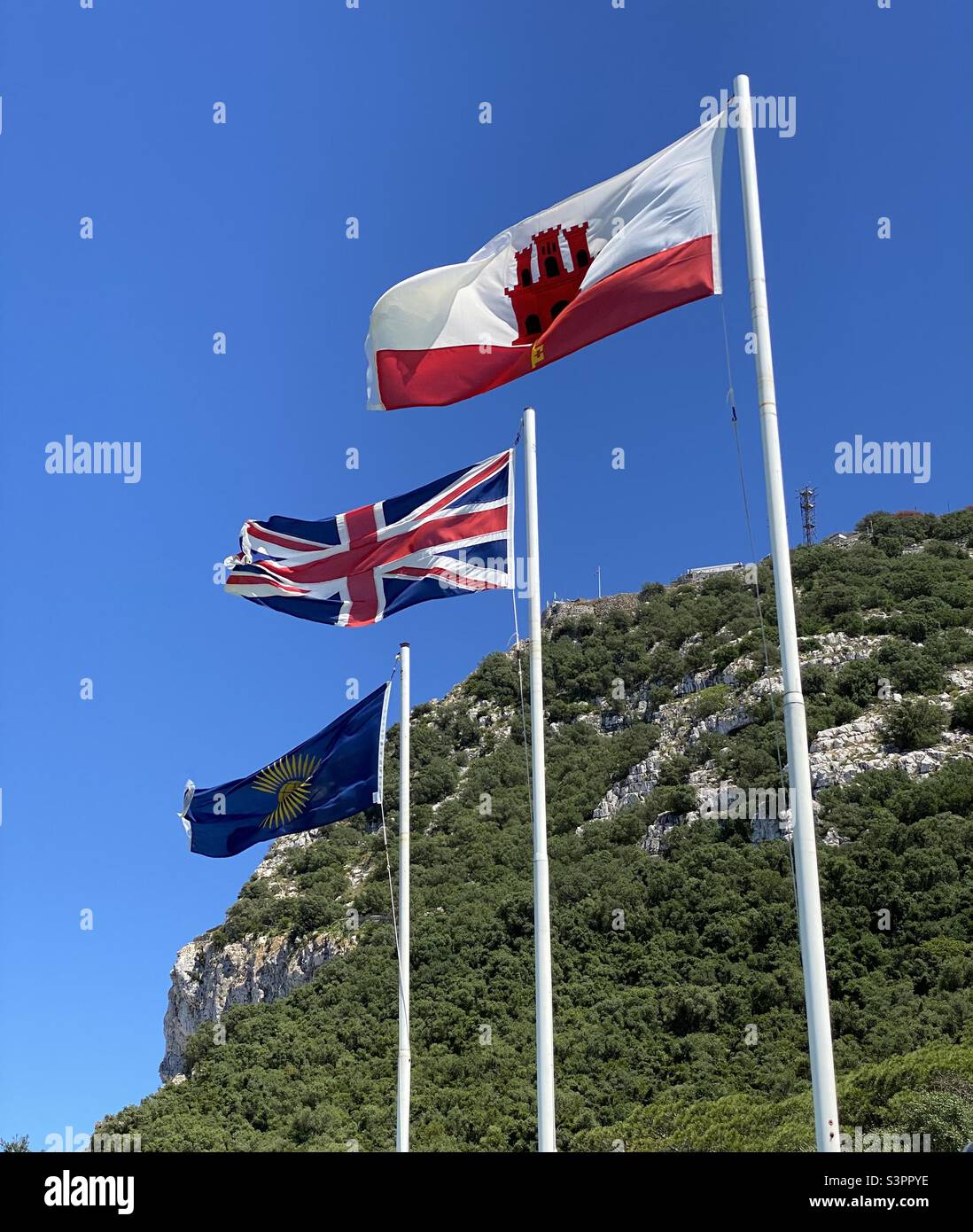 Flags flying in front of the rock of Gibraltar Stock Photo
