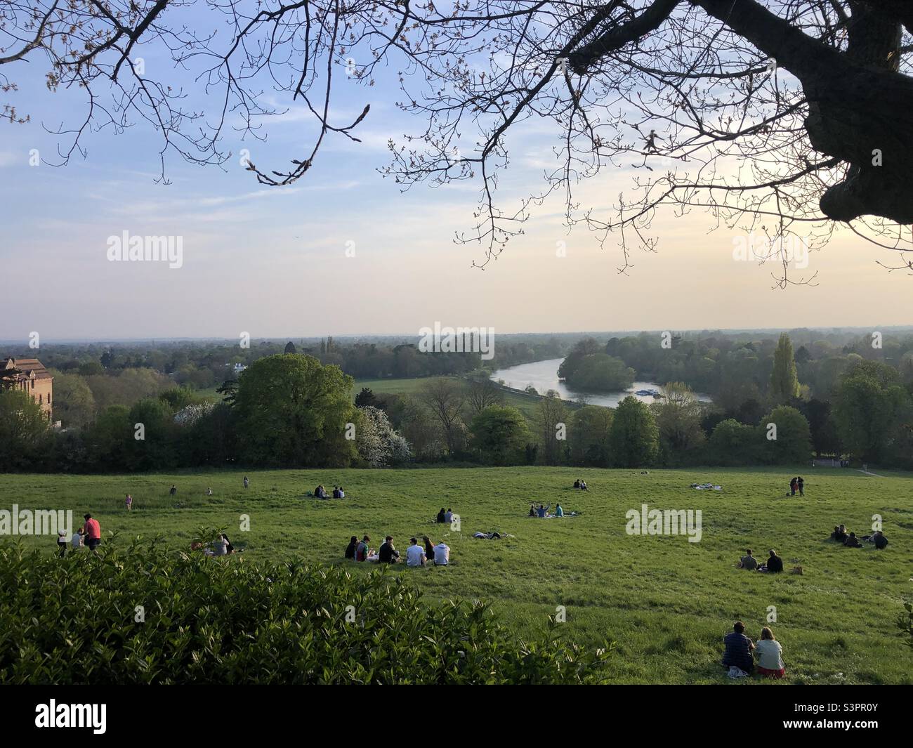 People sitting on grass on Richmond Hill of London on Easter Day  2022 Stock Photo