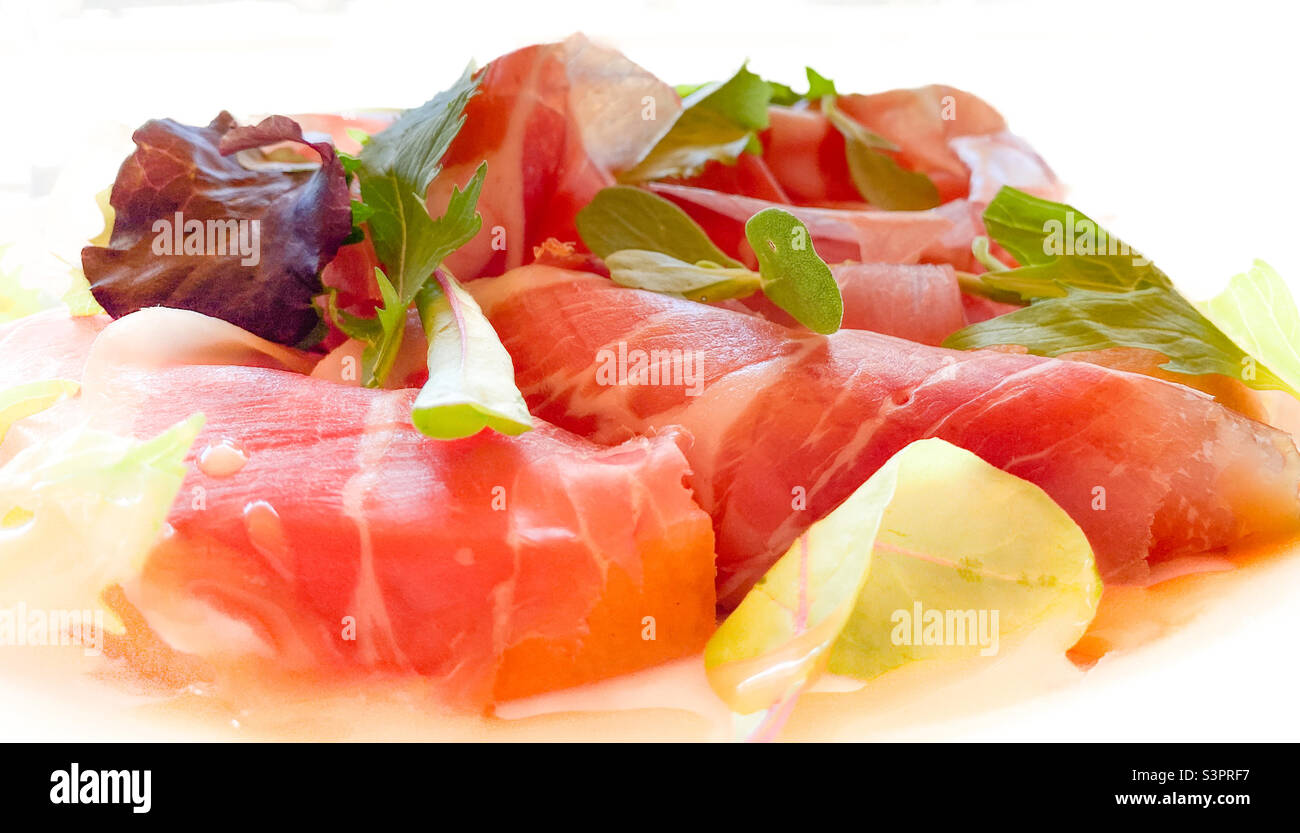 Plate of fresh Italian ham with garnish Stock Photo
