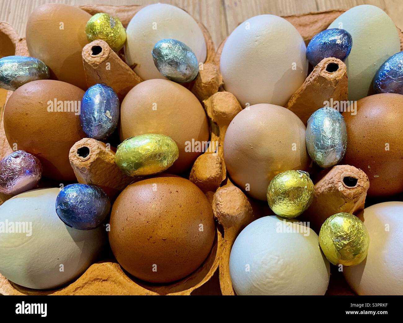 Real eggs and mini Easter eggs Stock Photo