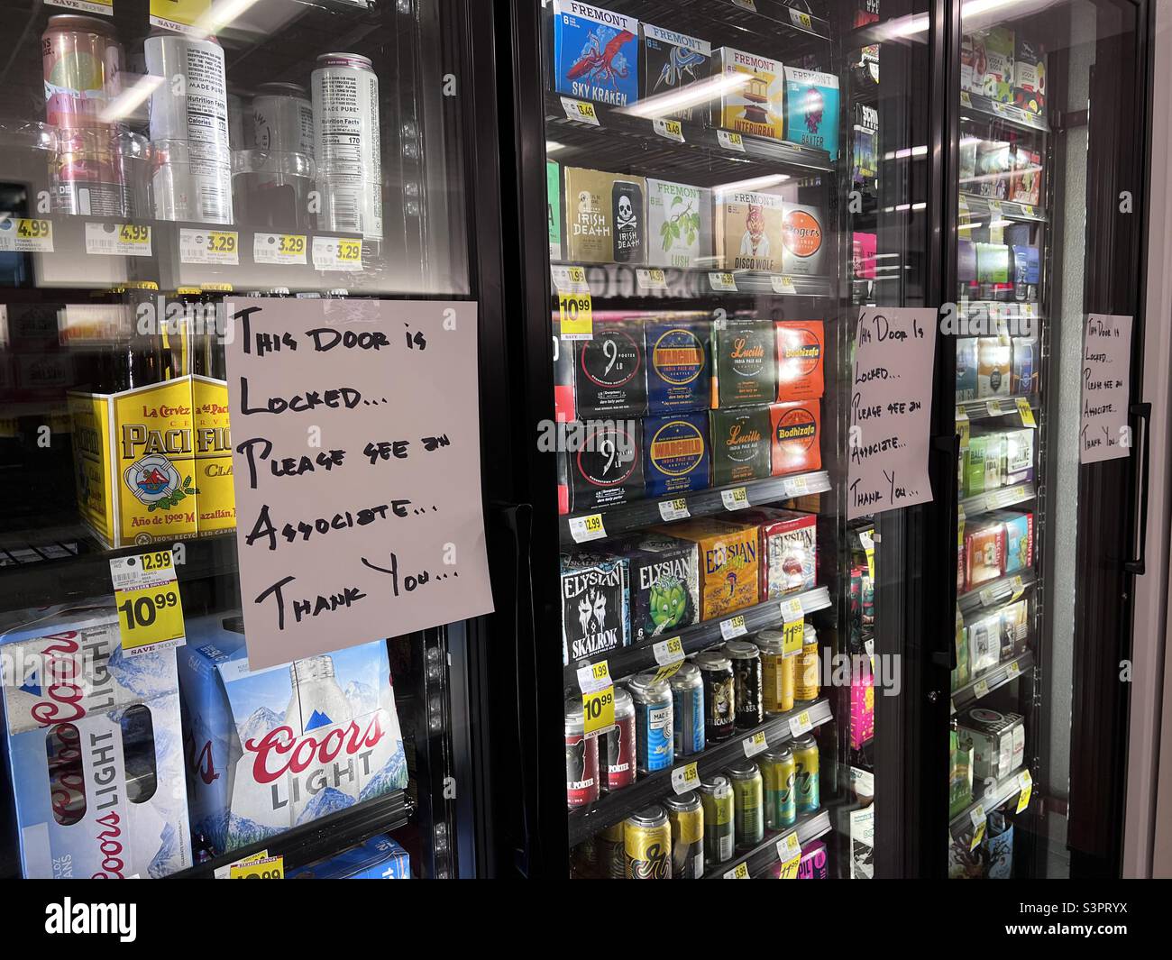 Seattle, USA. 18th April, 2022. Locked up alcohol at a Bartels store in Belltown. Seattle is experiencing a surge in crime in the downtown core prompting stores to begin locking up display cases. - Smartphone Captured Stock Image
