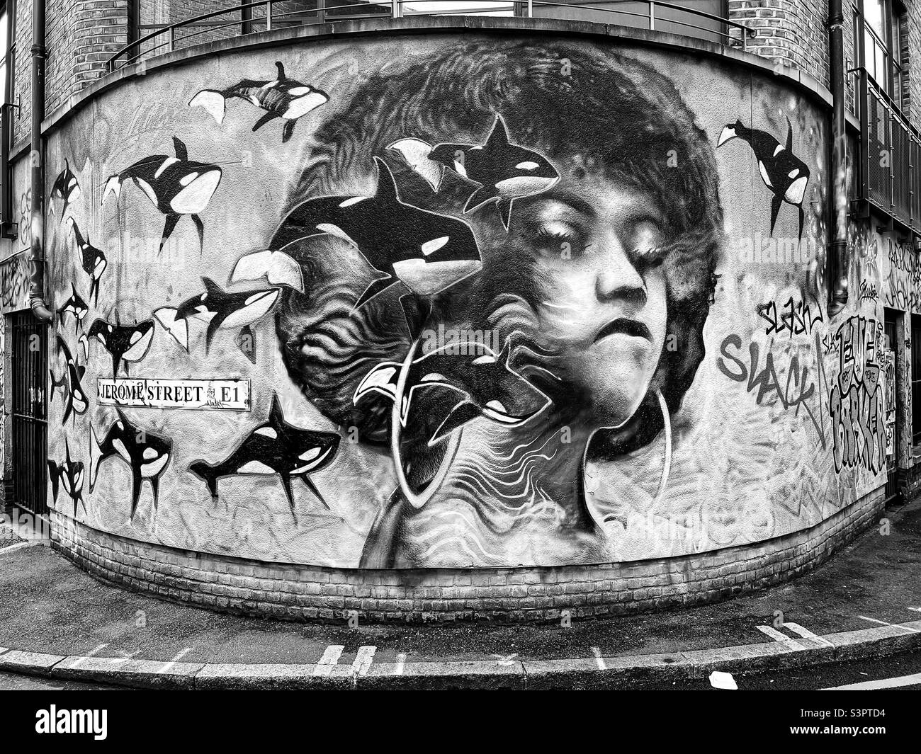 Black and white of graffiti street art on curved wall at Jerome Street, Shoreditch, London - January 2022. - Smartphone Captured Stock Image