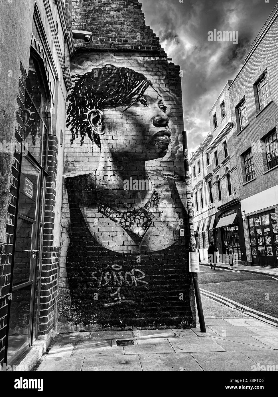 Black & white of graffiti street art, Brick Lane, Shoreditch, London - January 2022 - Smartphone Captured Stock Image