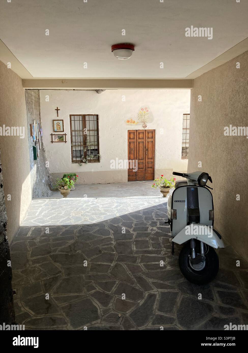 An alleyway and a courtyard in Siviano on the Monte Isola, Lago D‘Iseo, Lombardy, Italy - Smartphone Captured Stock Image