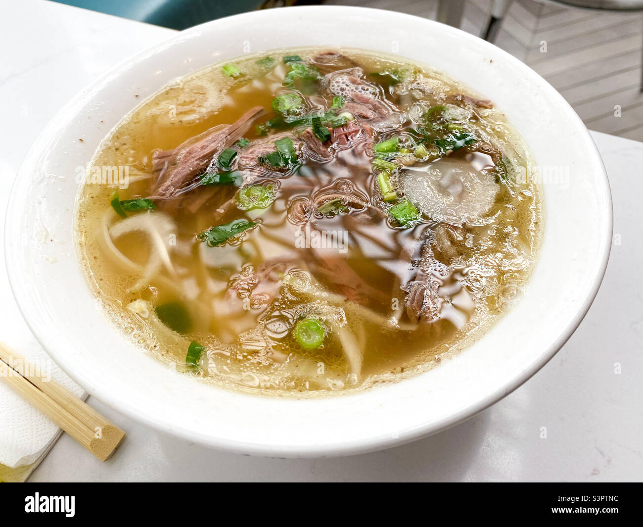 A bowl of Beef brisket pho.. a Vietnamese soup with noodles and beef. - Smartphone Captured Stock Image