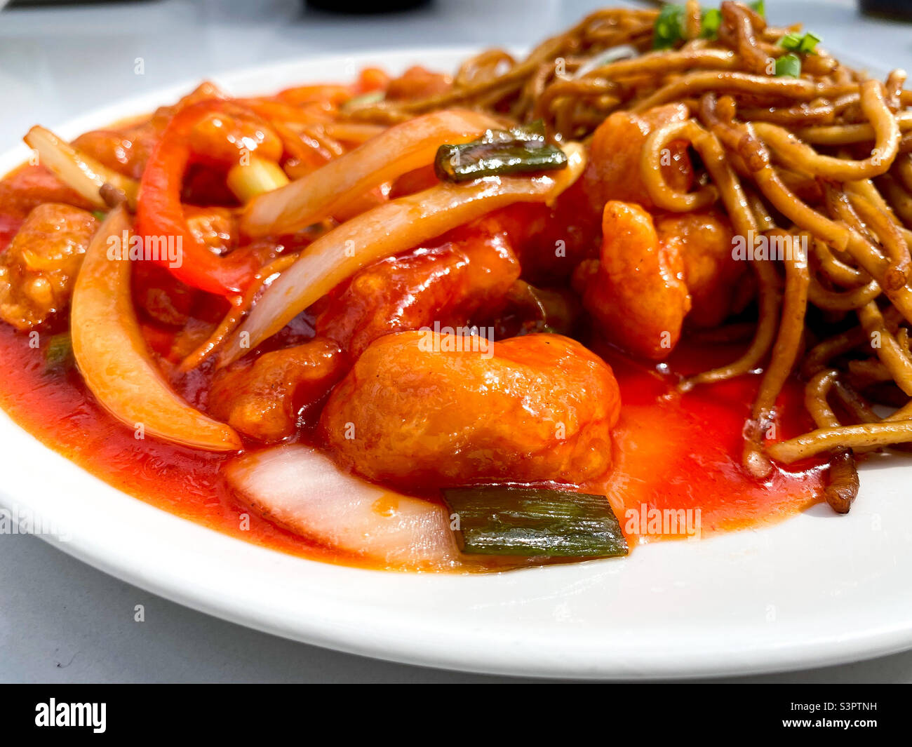 Sweet and sour chicken with wok fried noodles. - Smartphone Captured Stock Image