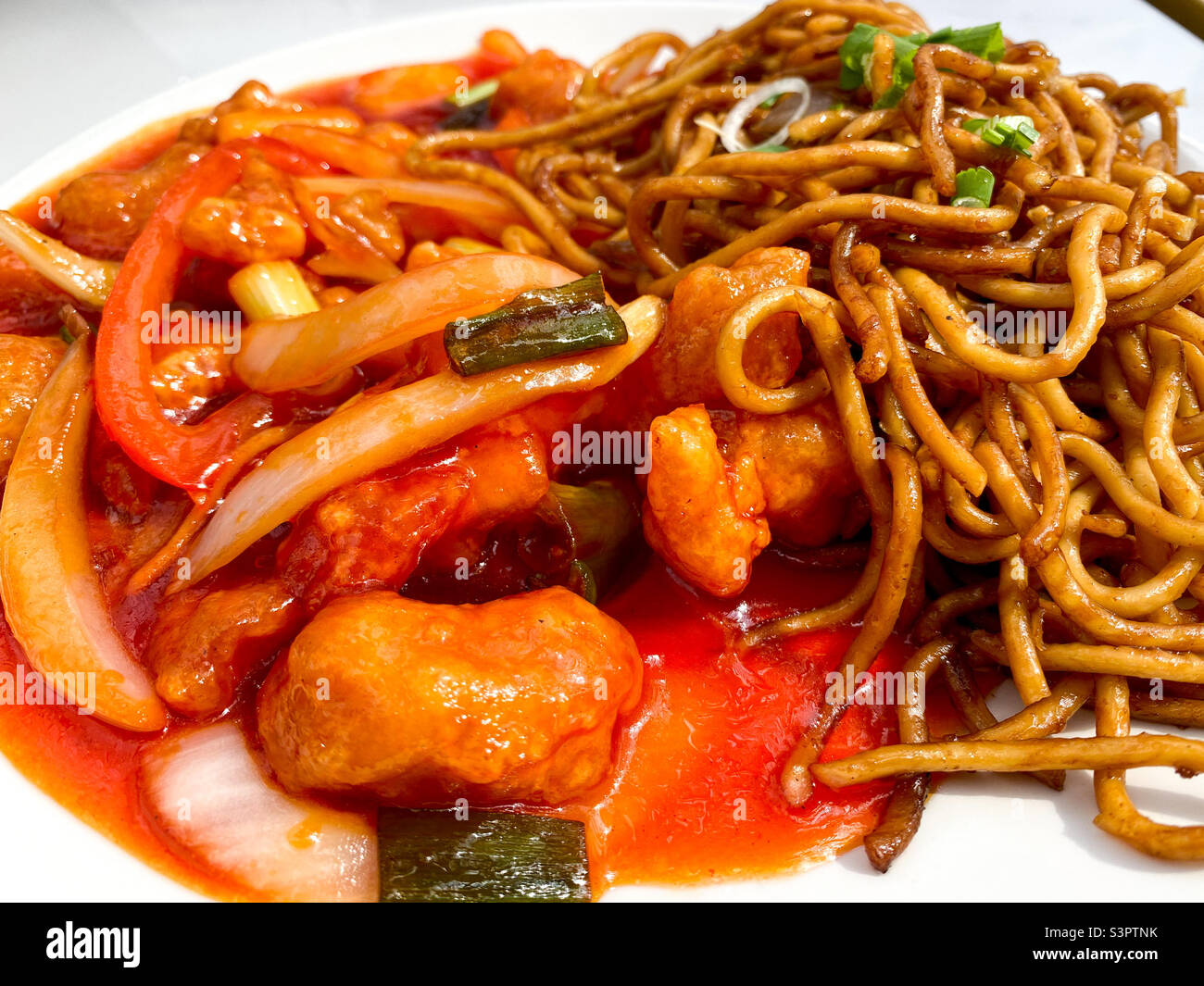 Sweet and sour chicken with wok fried noodles. - Smartphone Captured Stock Image