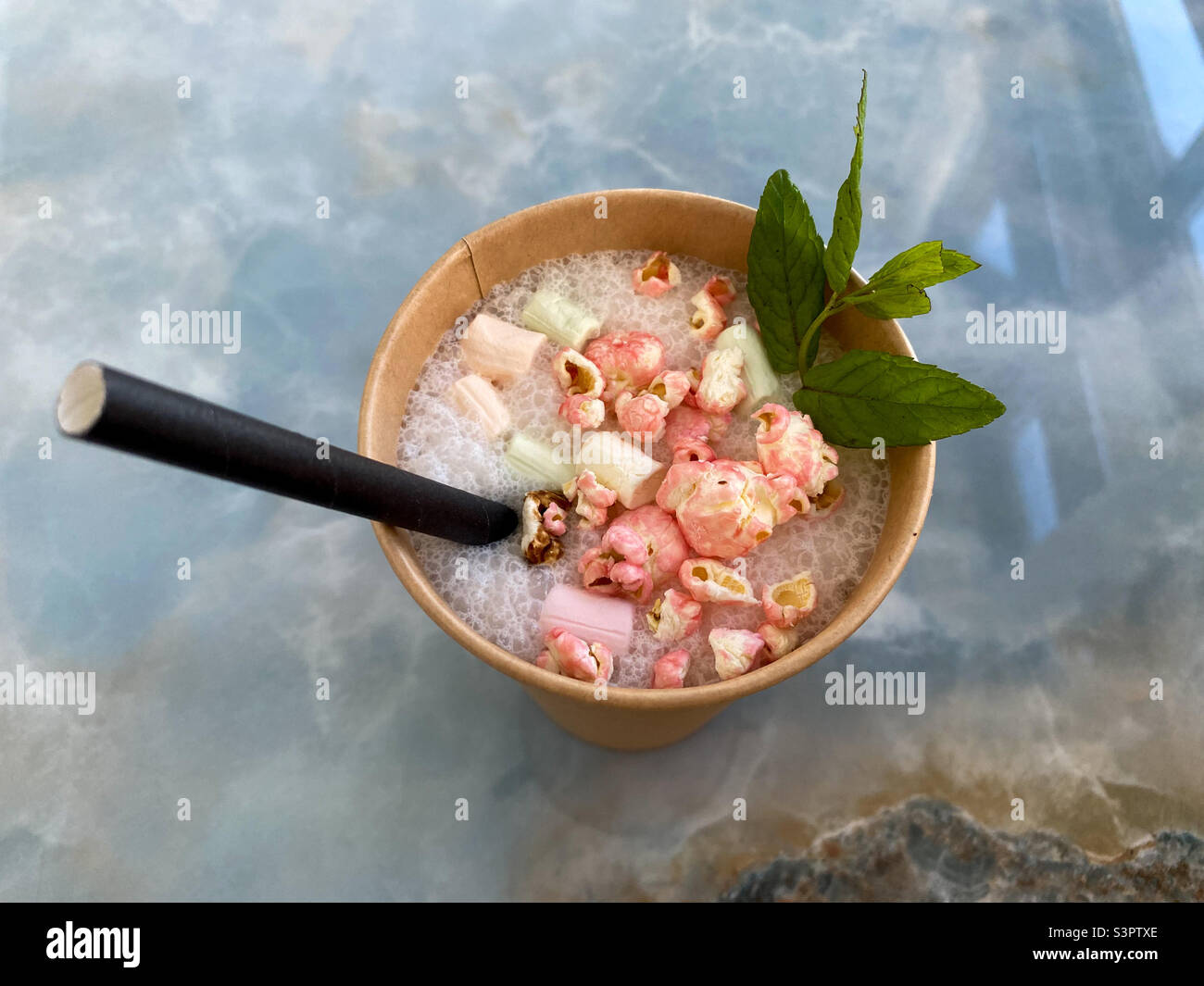 Bubble gum milkshake on an isolated marble background.  cocktail top view - Smartphone Captured Stock Image