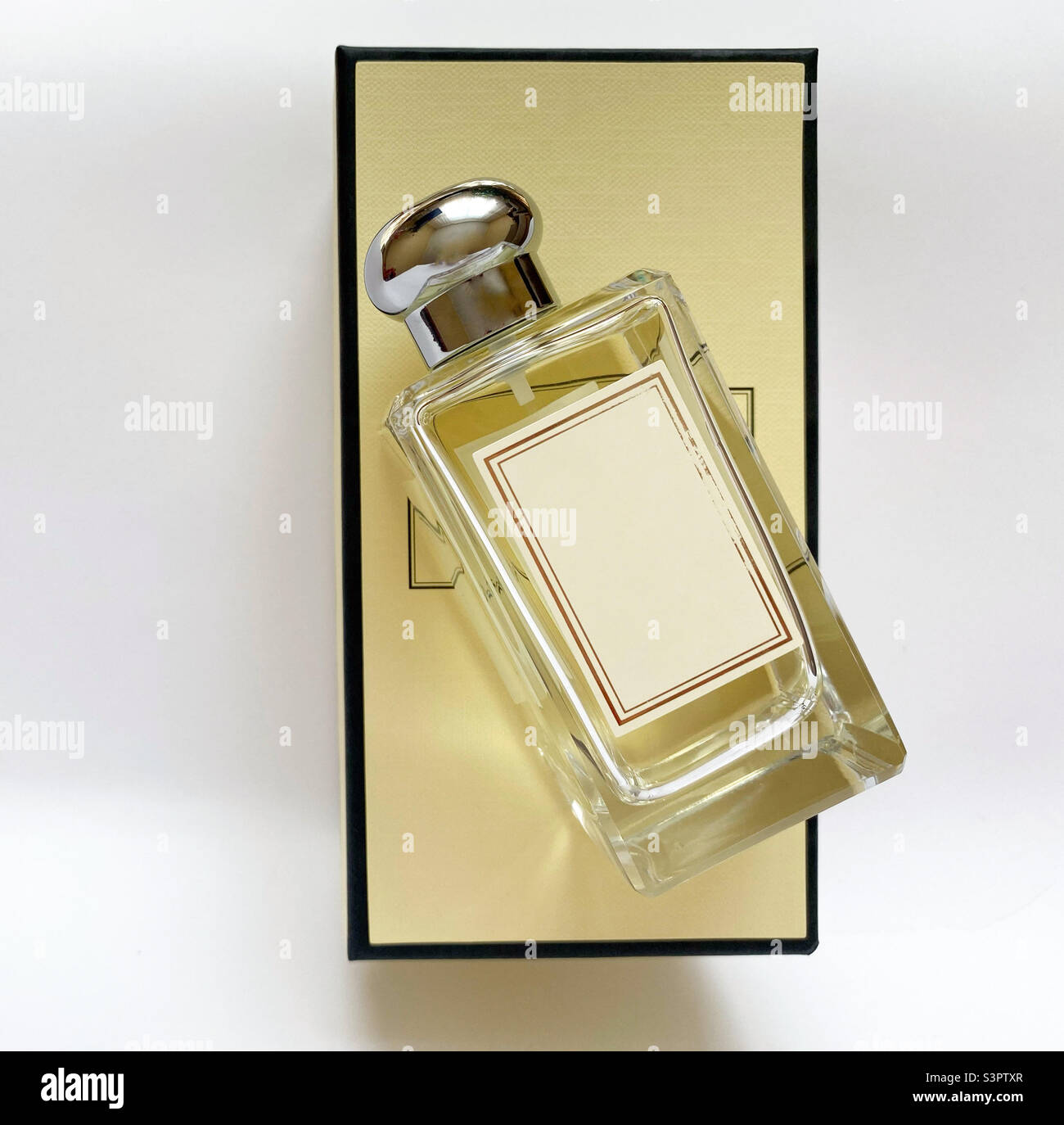 A bottle of perfume from a yellow box on a white isolated background ...