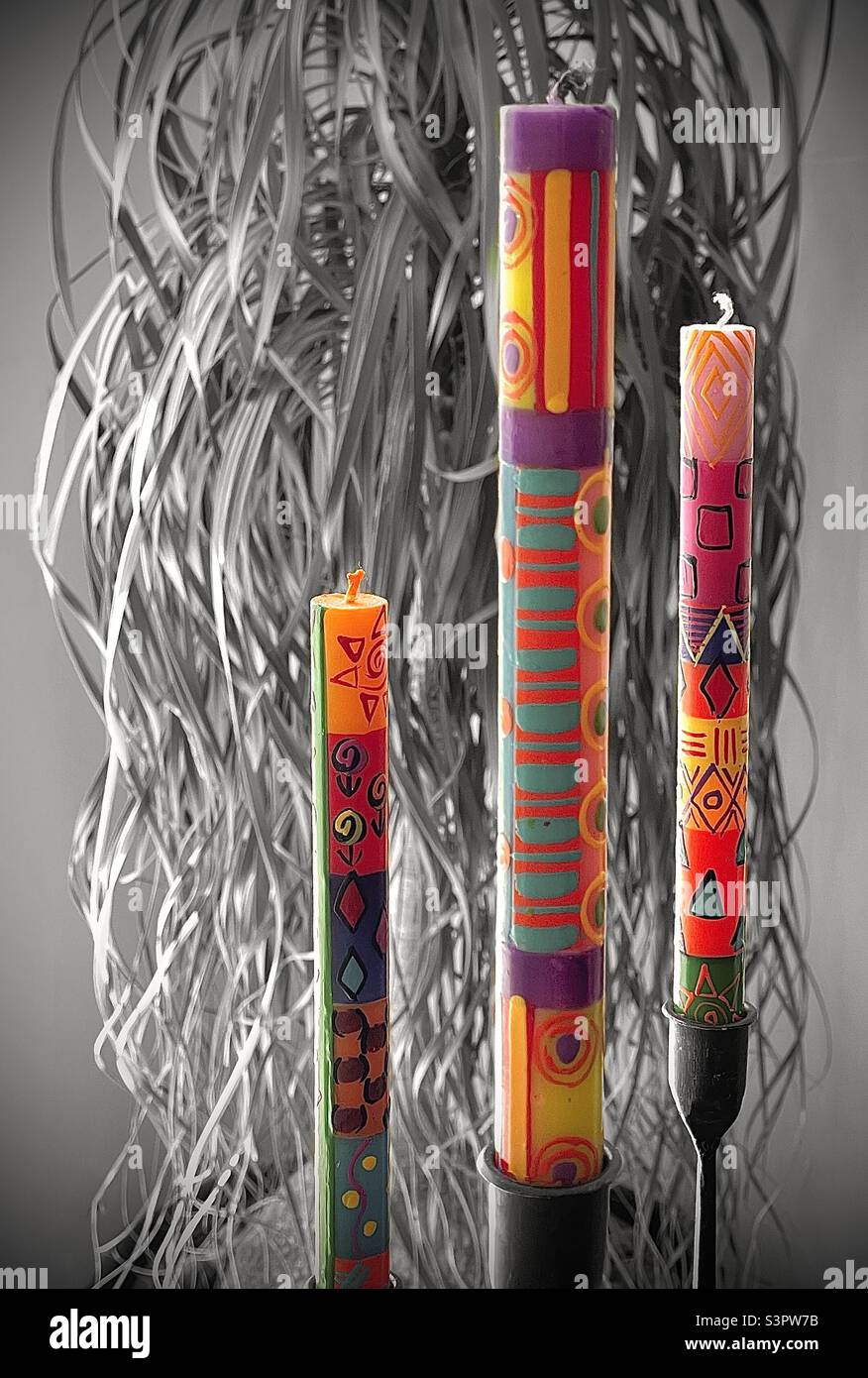 African hand-painted stick candles on a table inside a home in Utah, USA. Beautifully colored and designed, perfect for home decoration. - Smartphone Captured Stock Image
