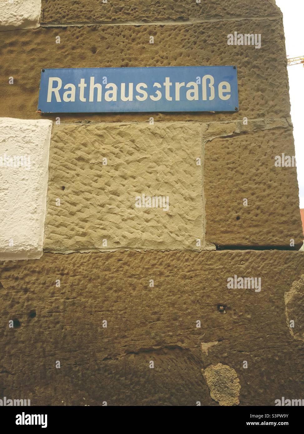 German street sign Rathausstraße translates into Townhouse street in English language - Smartphone Captured Stock Image
