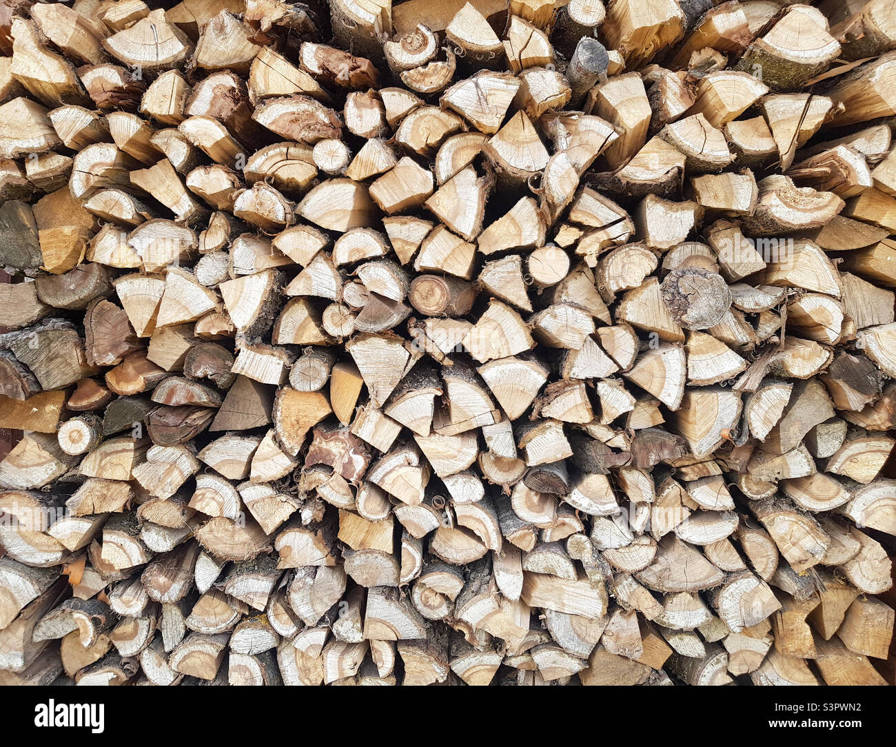 Background of chopped wood lying on top of each other.  Pile of chipped wood - Smartphone Captured Stock Image