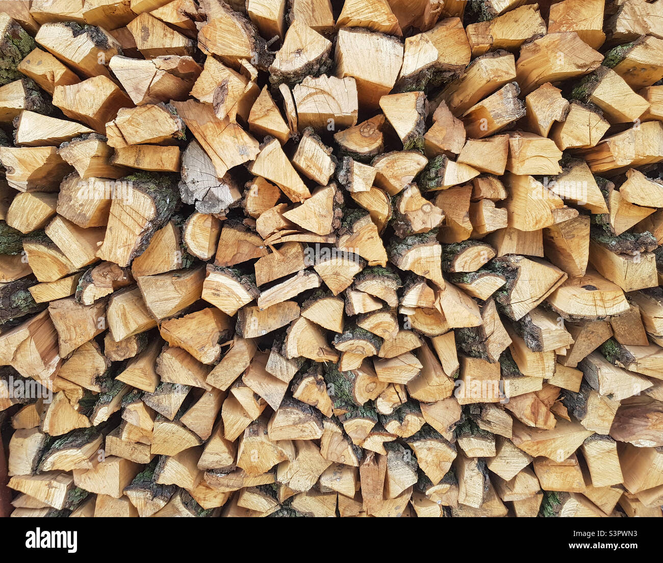 Background of chopped wood lying on top of each other. Pile of chipped wood close-up - Smartphone Captured Stock Image