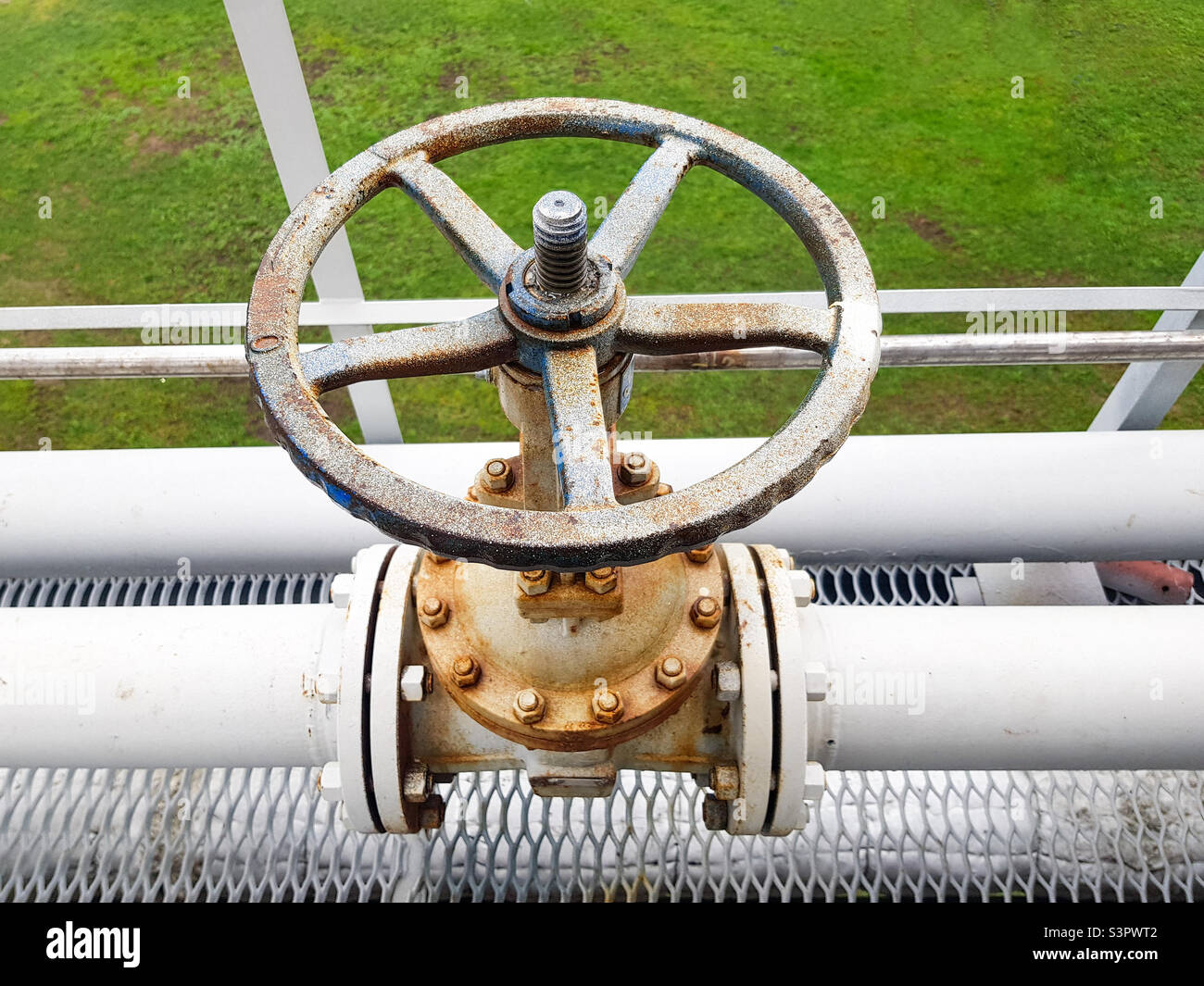 Closing or opening for gas or water supply through a pipeline.  Shut-off valves on the pipeline close-up - Smartphone Captured Stock Image