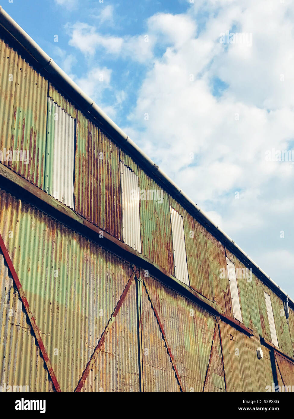 An old warehouse in Bristol clad in green corrugated metal Stock Photo