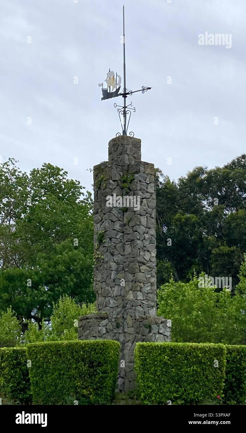 Stone column with a weather vane in the shape of a sailing ship in the middle of a junction Sardinero Santander Cantabria Spain - Smartphone Captured Stock Image