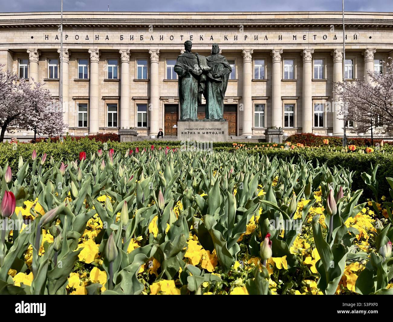 Spring flowers and the Monument to Cyril and Methodius brothers at the National Library in Sofia Bulgaria, Eastern Europe, Balkans, EU - Smartphone Captured Stock Image