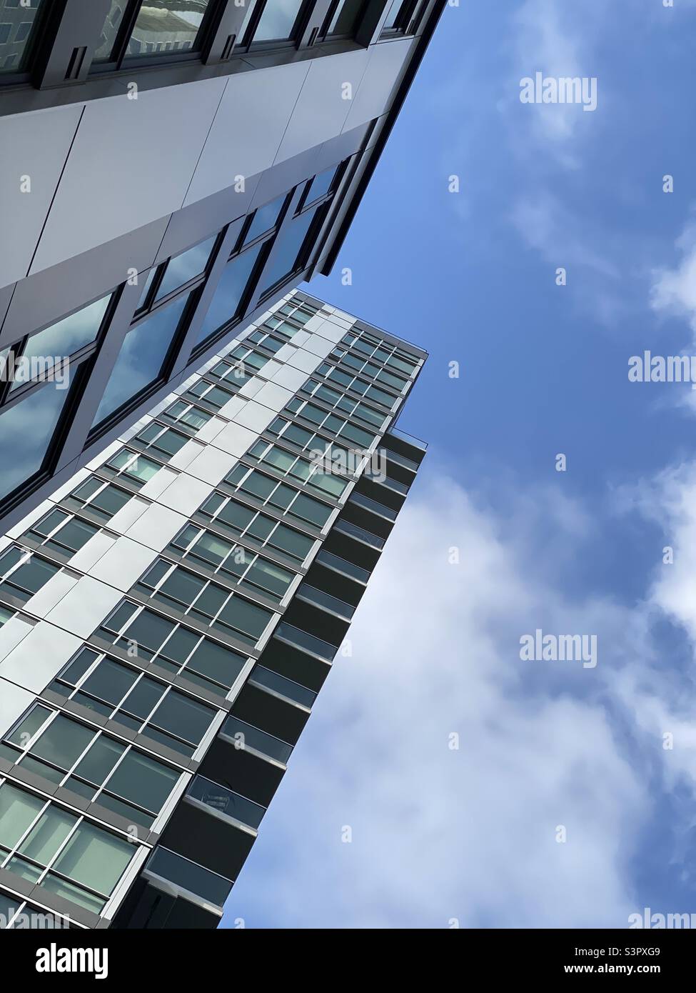 Looking up at tall apartments buildings in Downtown Los Angeles, sky and clouds in background - Smartphone Captured Stock Image