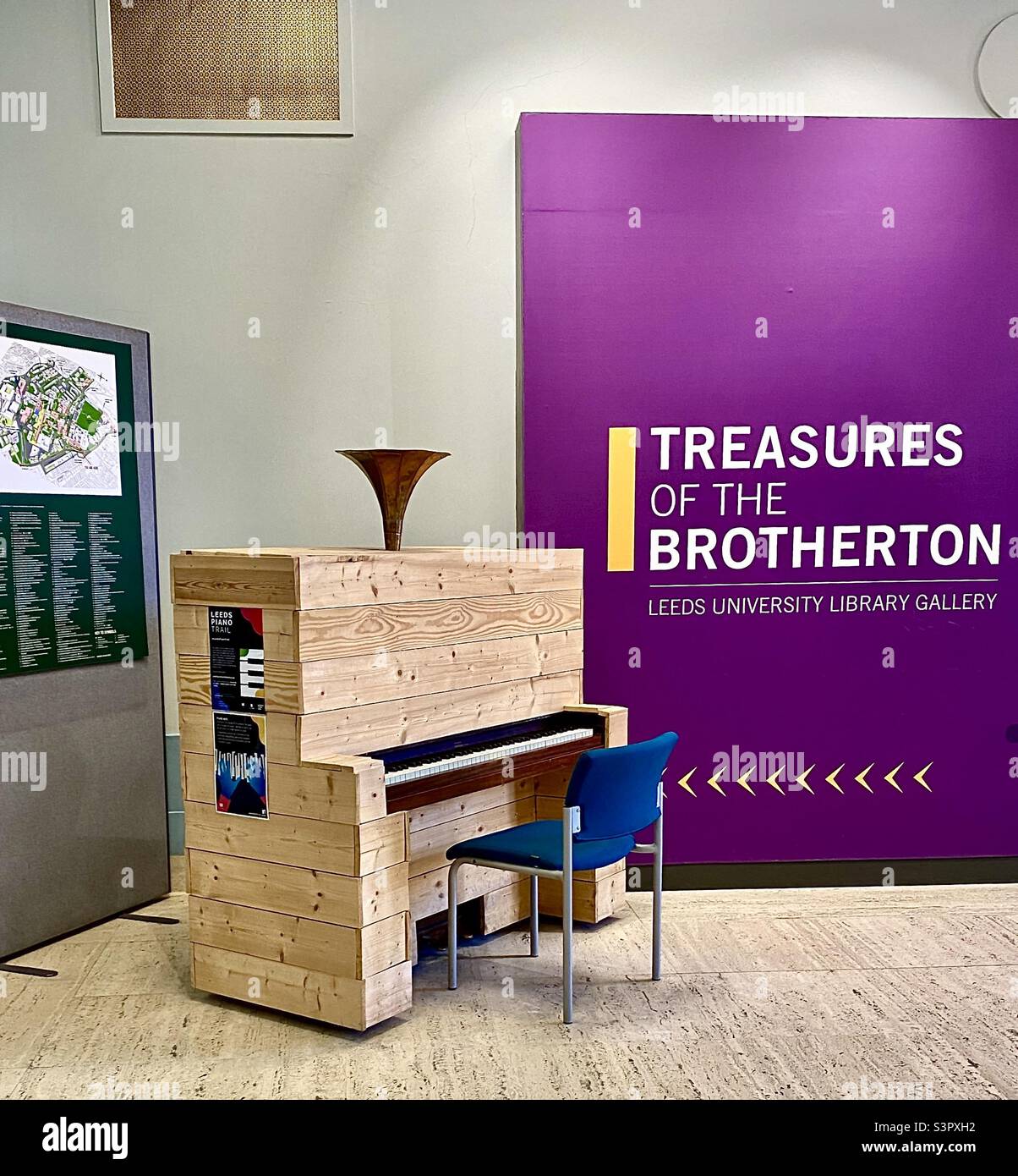 Unusual piano in the foyer of the University of Leeds Brotherton Library. A nearby sign advertises treasures held in the Special Collections. The Leeds International Piano Competition is a partner. Stock Photo