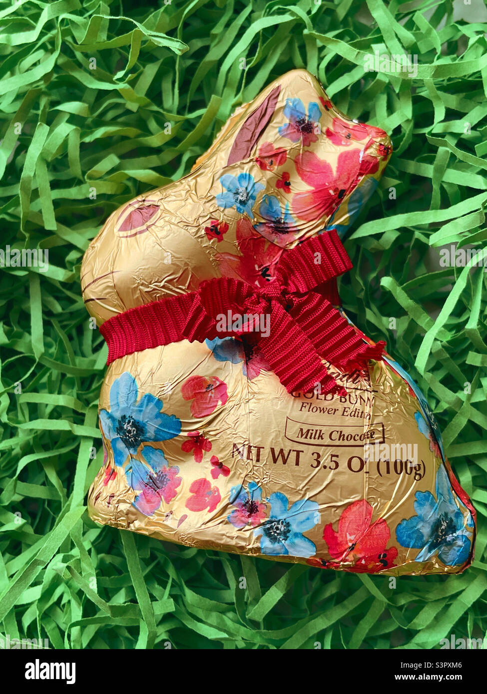 Lindt milk Chocolate Easter bunny with floral decorations 2022 Stock Photo
