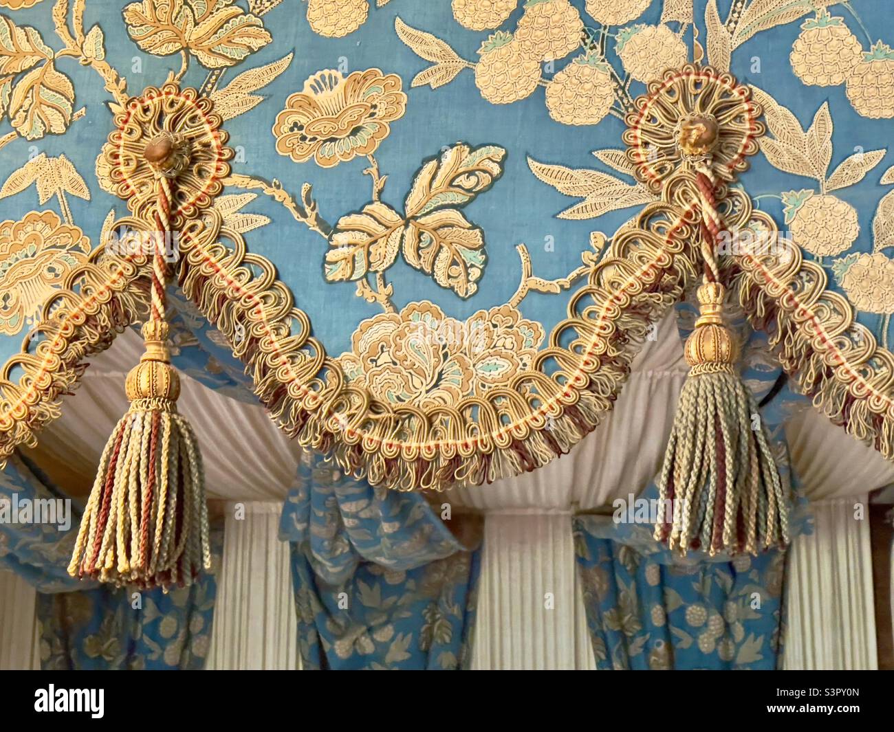 The braid and tassels on the scalloped canopy of a four-poster bed In the Worcestershire County Museum at Hartlebury Castle - Smartphone Captured Stock Image