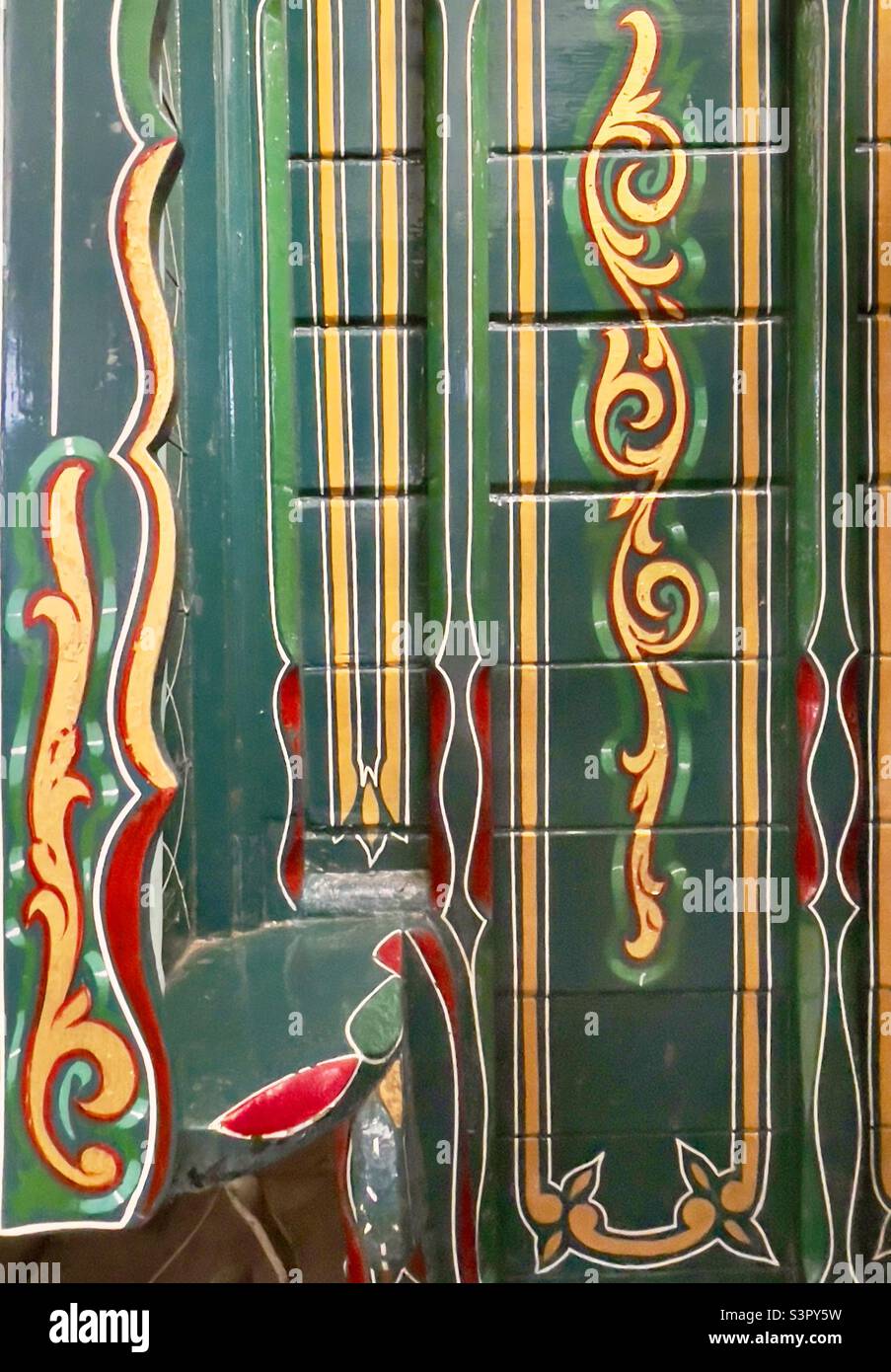 A detail of the carriage painting on a gypsy caravan in the museum at Hartlebury Castle in Worcestershire UK - Smartphone Captured Stock Image