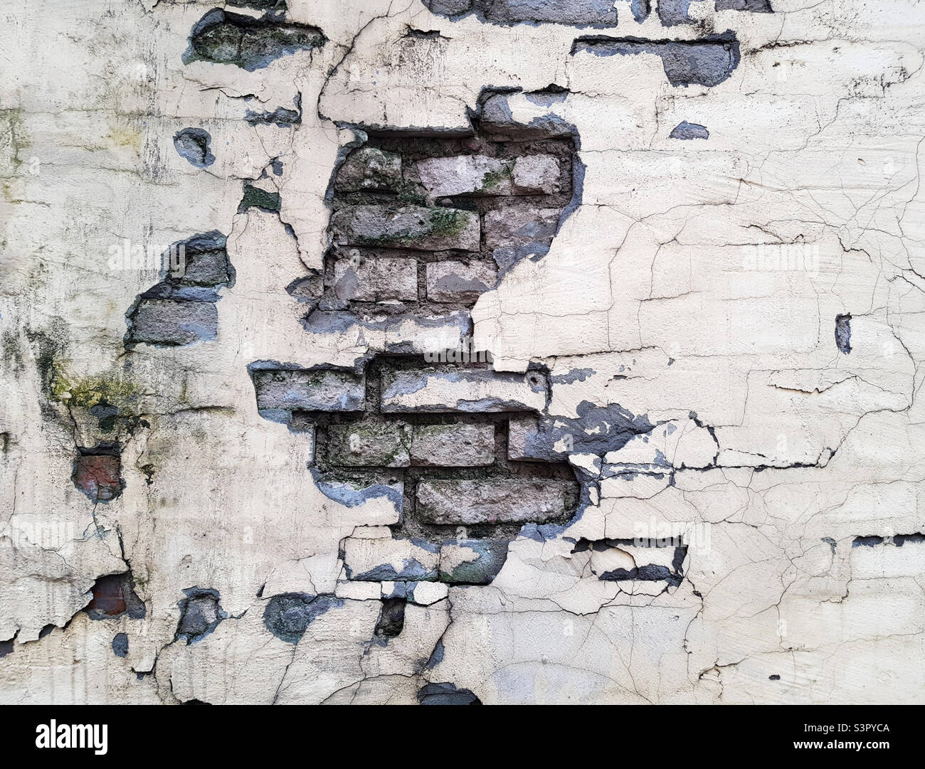 Background of a crumbling brick wall close-up. The texture of a crumbling wall - Smartphone Captured Stock Image