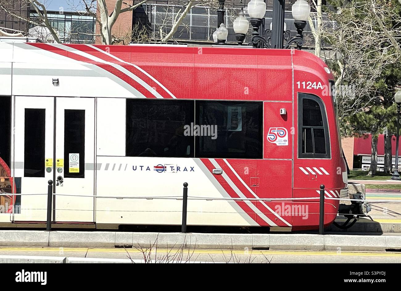 UTA (Utah.Transit Authority) TRAX train traveling up South Temple in Salt Lake City, Utah, USA between the Triad Center (a local media hub) and the Vivint Arena (home of the NBA team, the Utah Jazz). Stock Photo