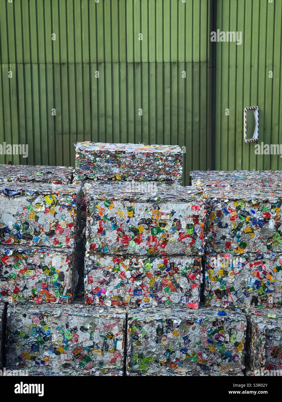 Aluminium cans packaged up into cubes at a recycling centre - Smartphone Captured Stock Image