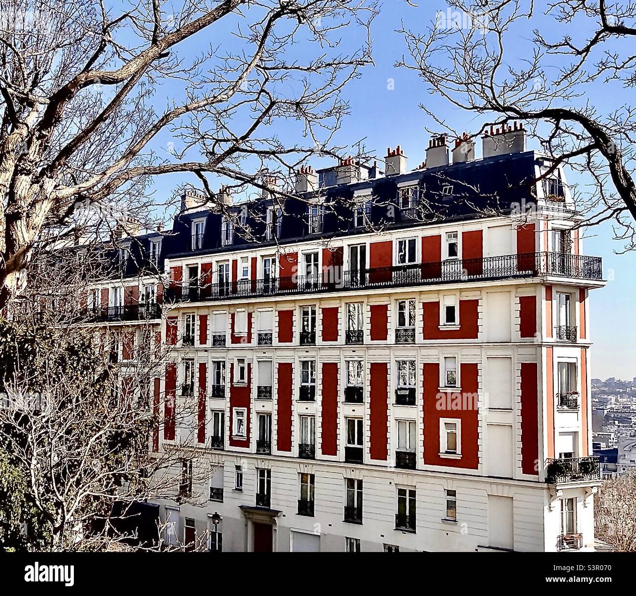 Elegant apartments high on Rue Lamarck at the eastern side of the Sacre Coeur Basilica in Paris. Nearby are extensive views over Paris. Below, at street level are numerous restaurants. Stock Photo