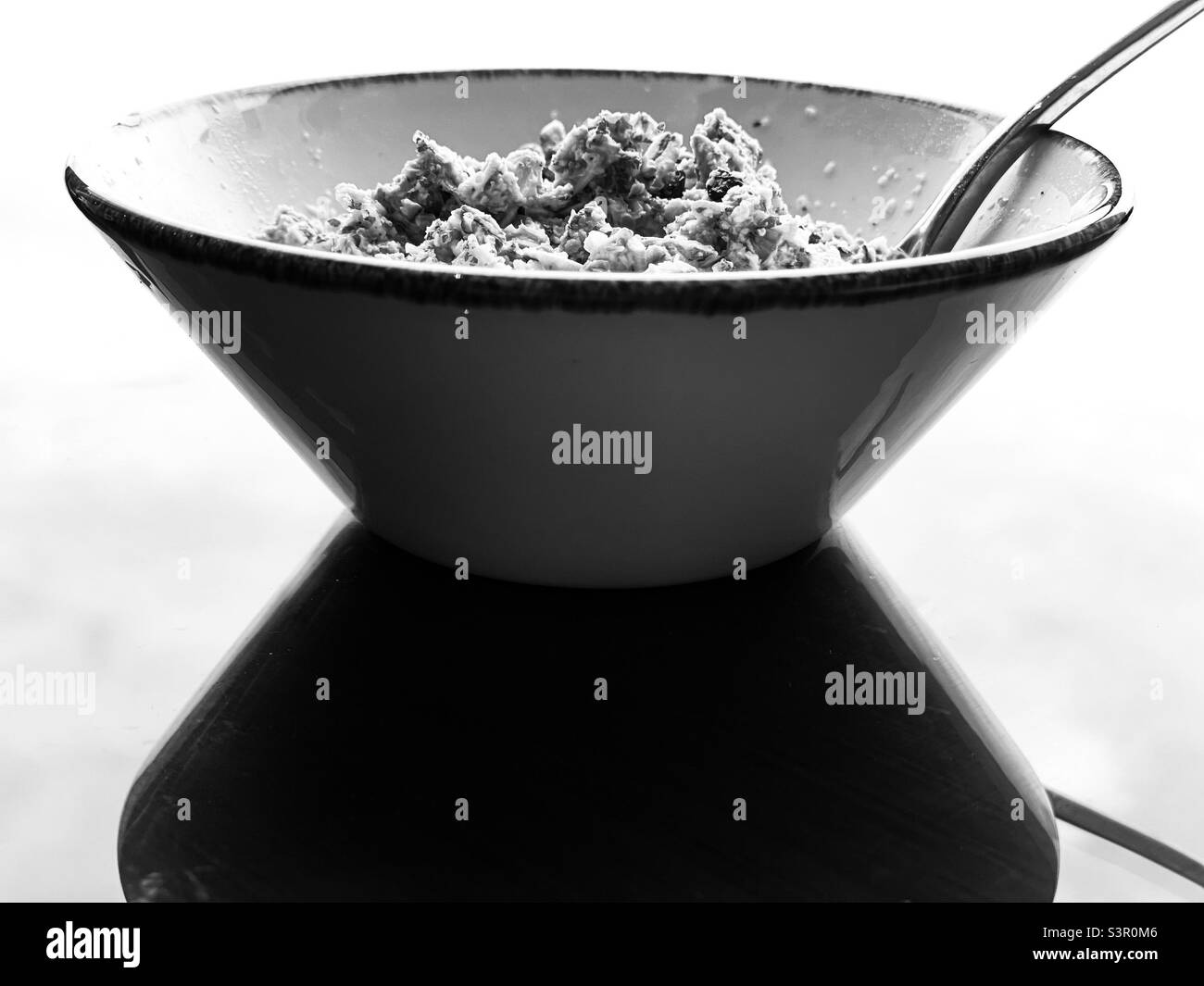 Black and white geometric photo of a bowl of musli cereal Stock Photo