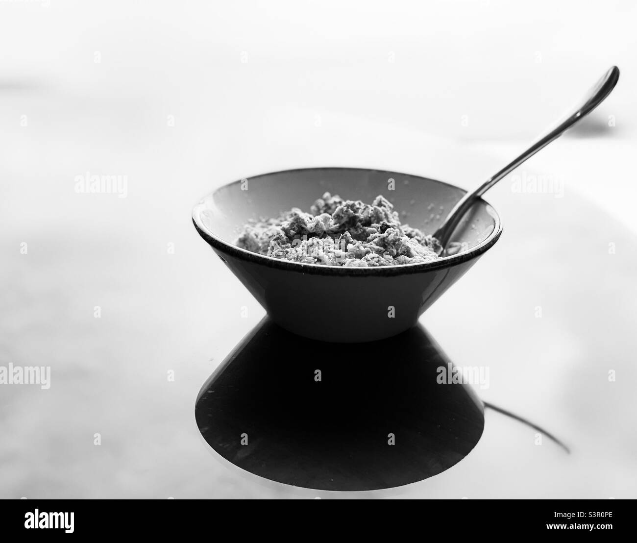 Small bowl of musli cereal for breakfast in black and white Stock Photo