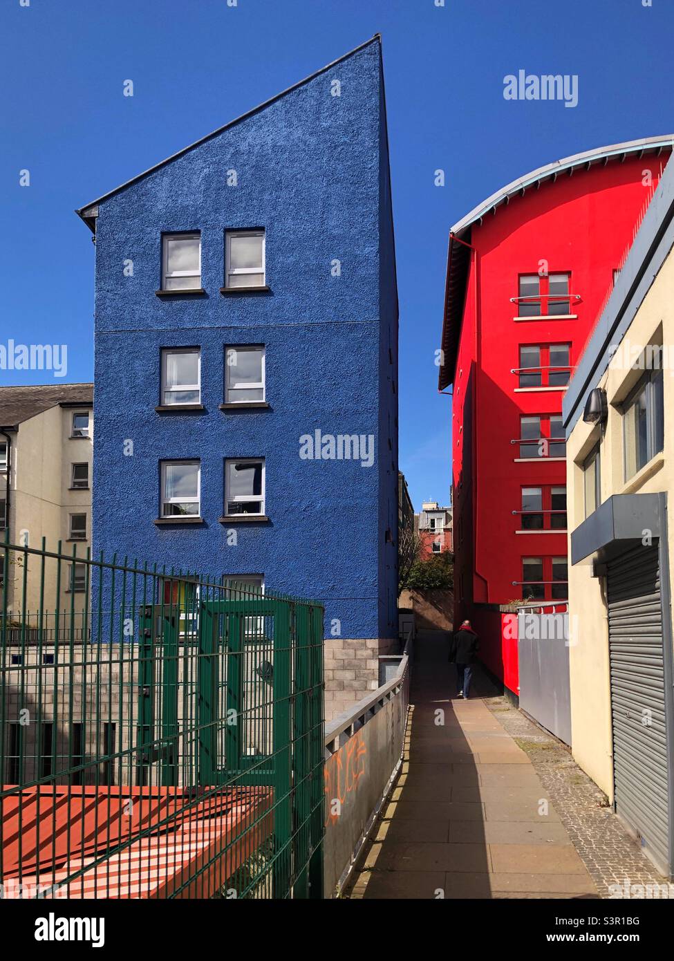 Red and blue building against a blue sky Stock Photo - Alamy