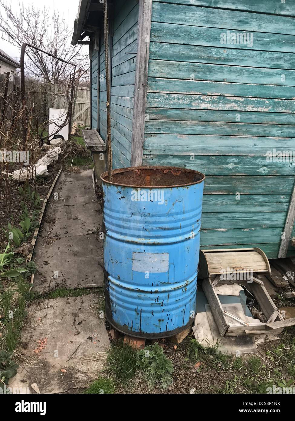 blue barrel in rural garden Stock Photo Alamy