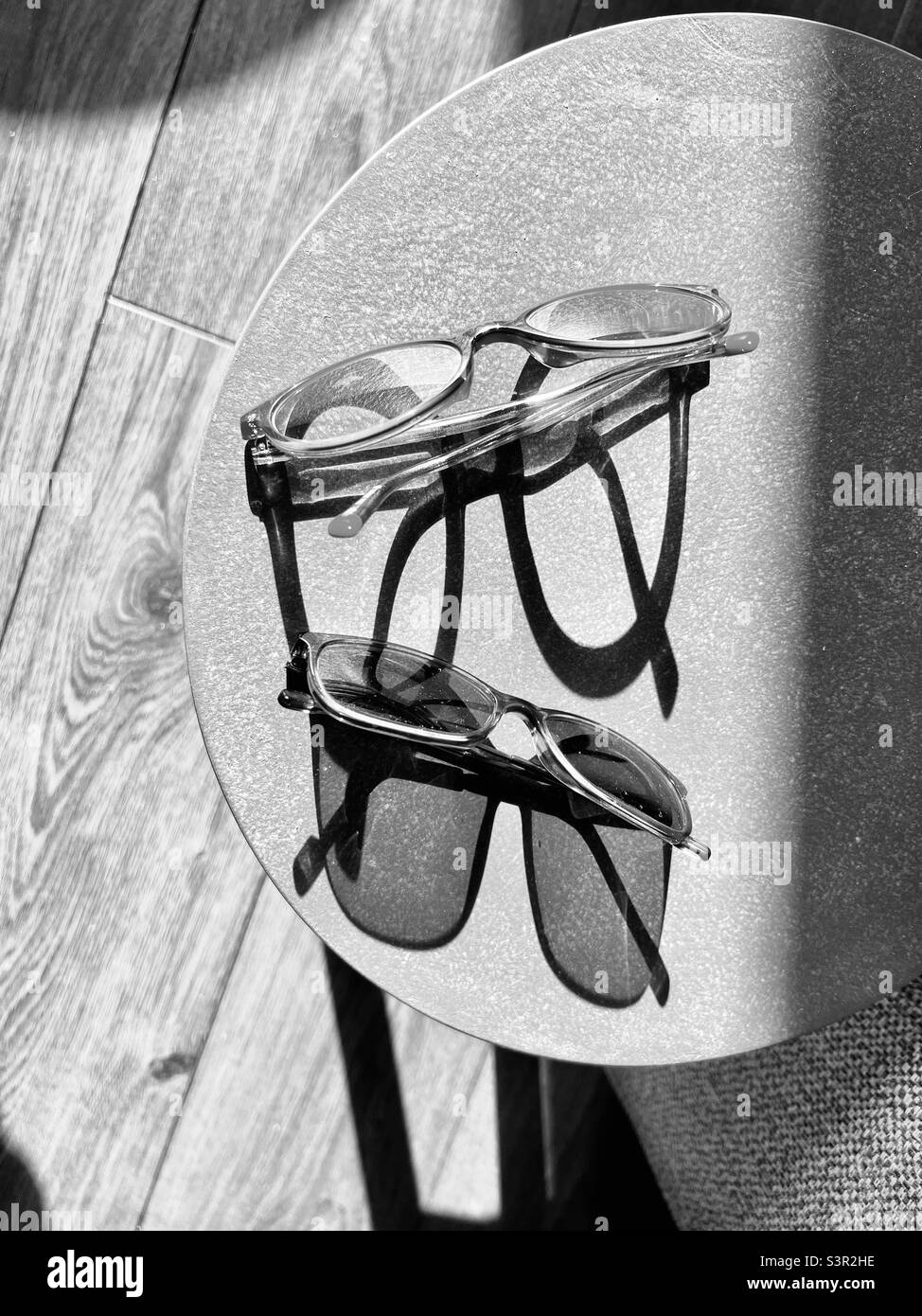 Glasses and their shadows in strong sunlight Stock Photo