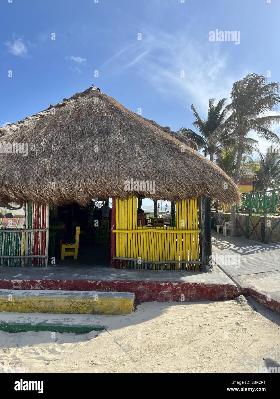 Red Gold and Green, Rasta beach hut café Cozumel Mexico Mexican Island secluded Stock Photo