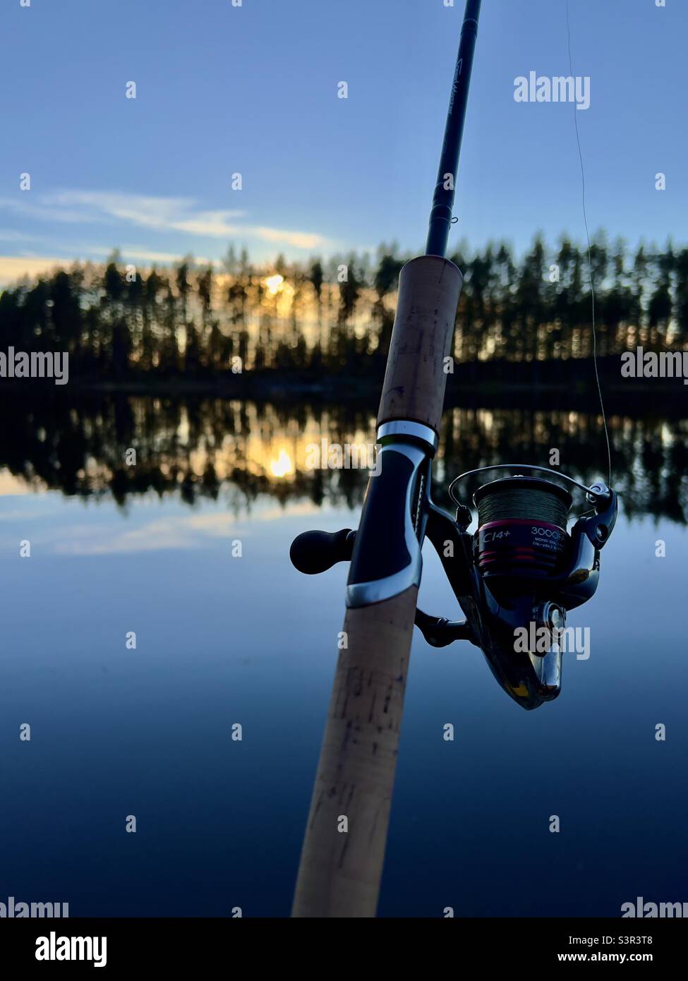 Fishing rod with sunset background - Shimano Stock Photo