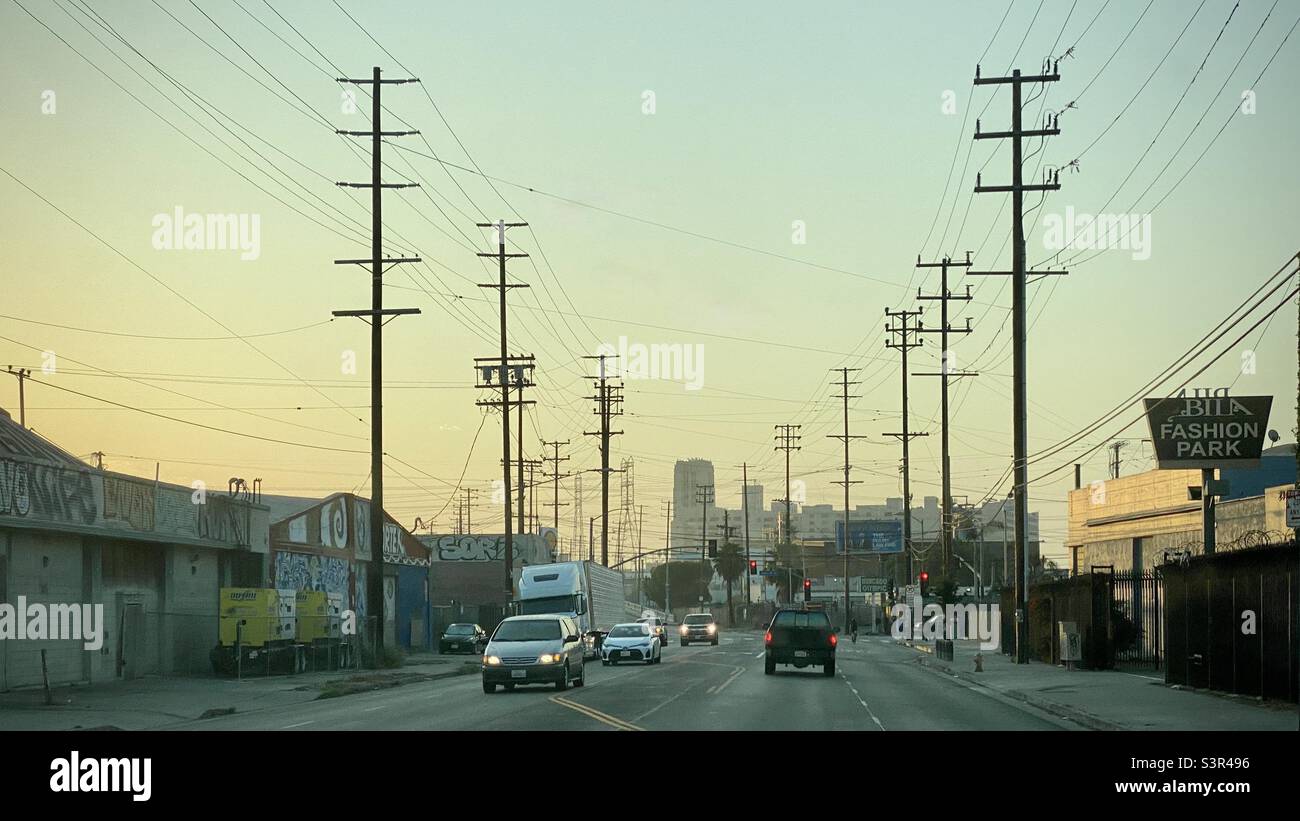 LOS ANGELES, CA, JUN 2021: traffic passing along Olympic Blvd near the Arts District in Downtown, with former Sears Building in background, sunrise - Smartphone Captured Stock Image