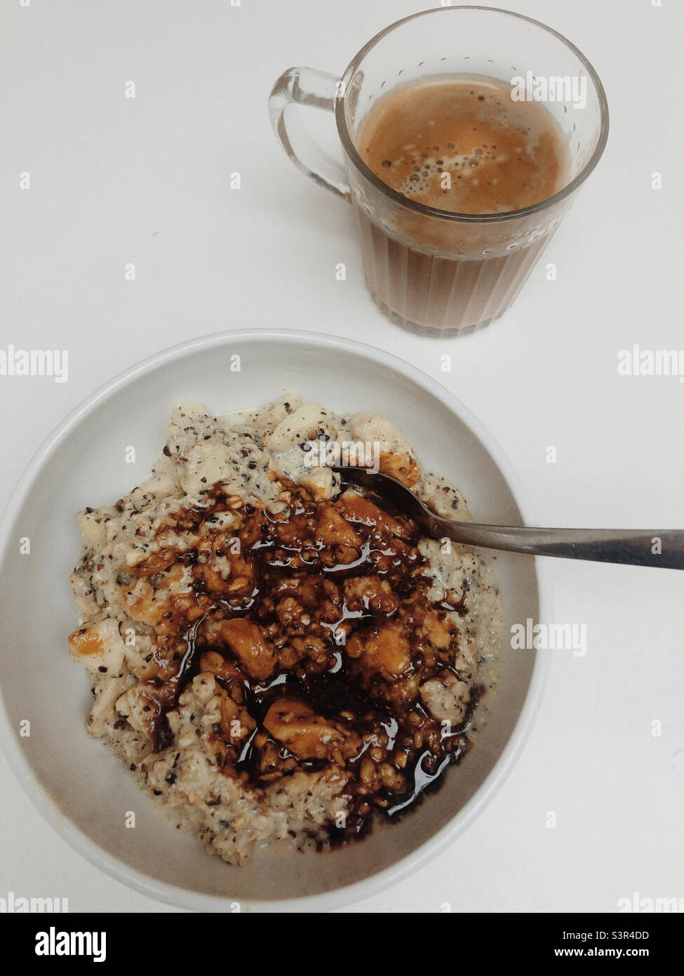 Oat meal porridge served with coffee that is also served with oat milk vegan breakfast - Smartphone Captured Stock Image