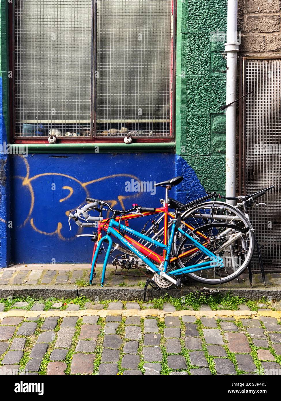 Chained up Bicycles missing front wheel - Smartphone Captured Stock Image