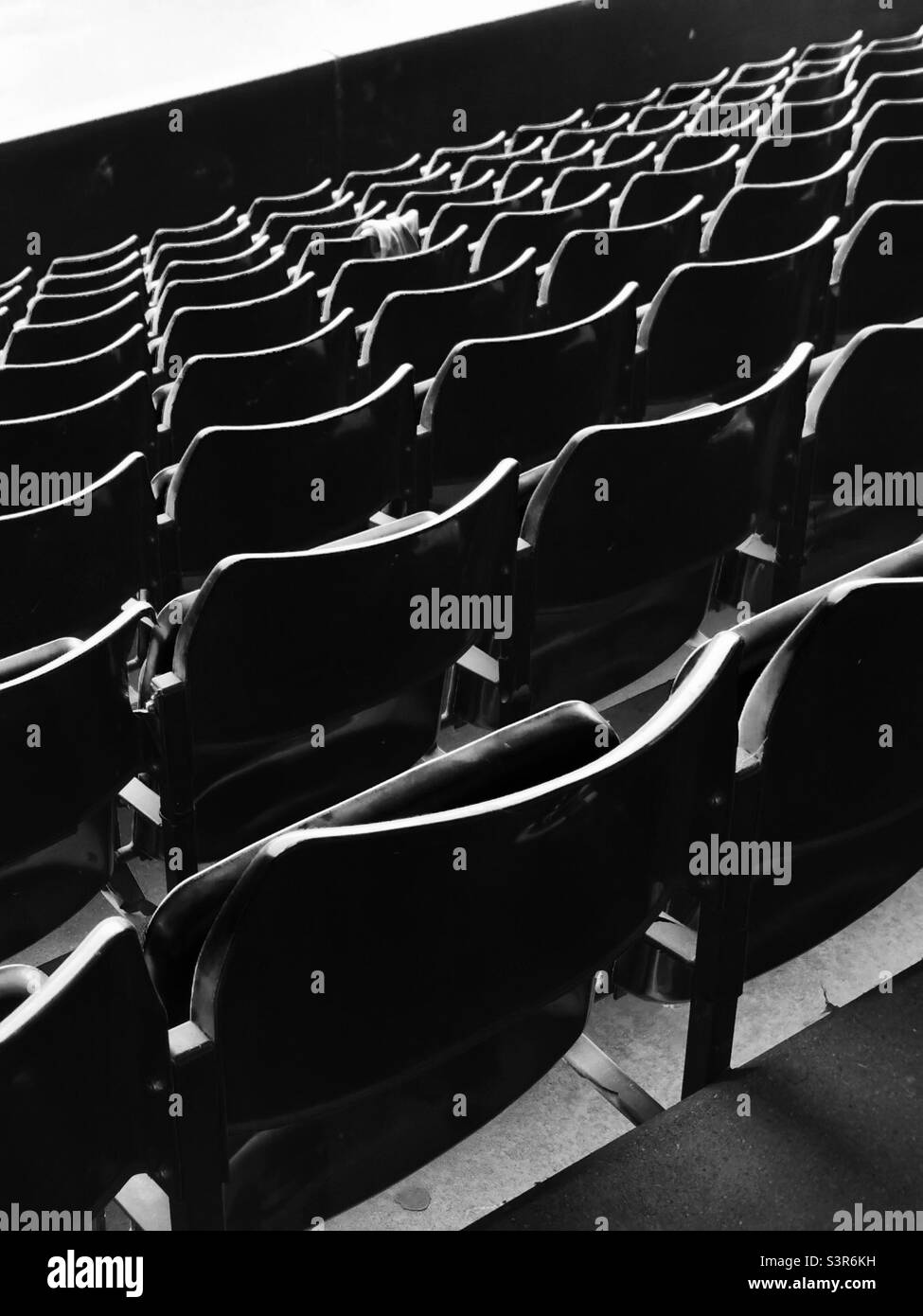 black & white rows of chairs on stadium Stock Photo