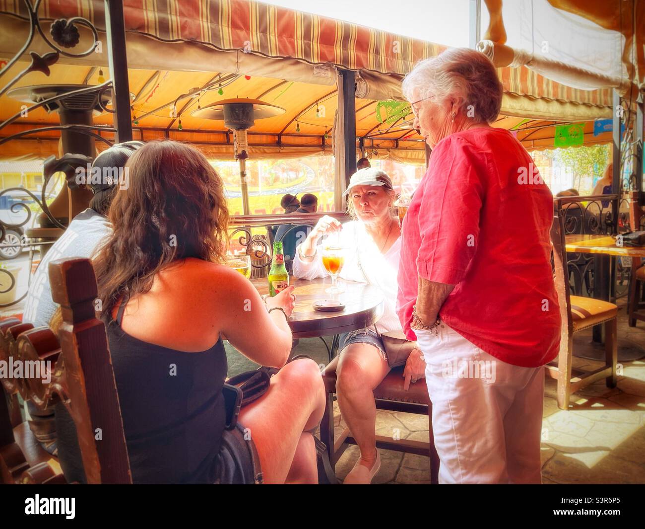 People talking at an outdoor covered patio - Smartphone Captured Stock Image
