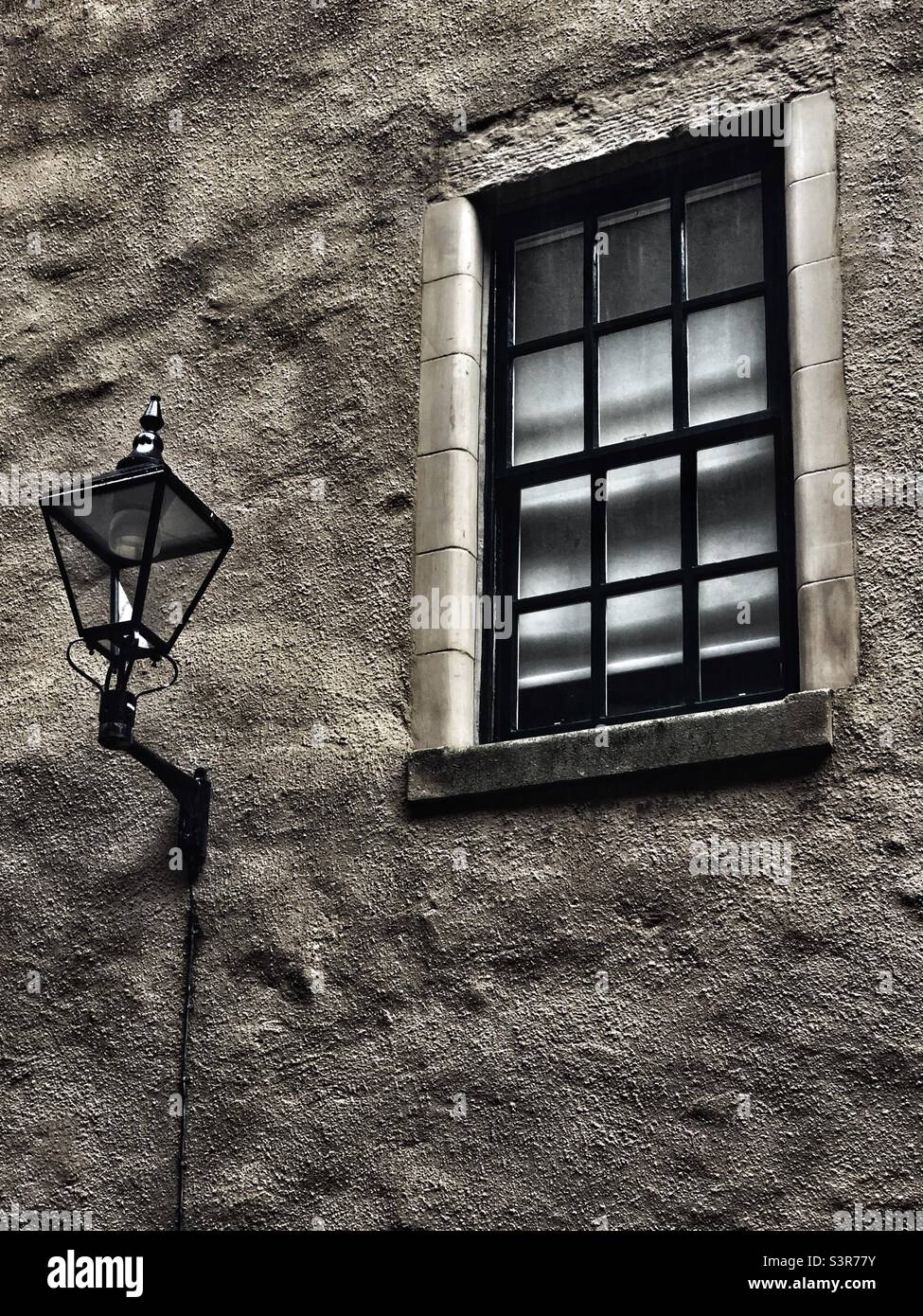 Old style lamp on side of building - Smartphone Captured Stock Image