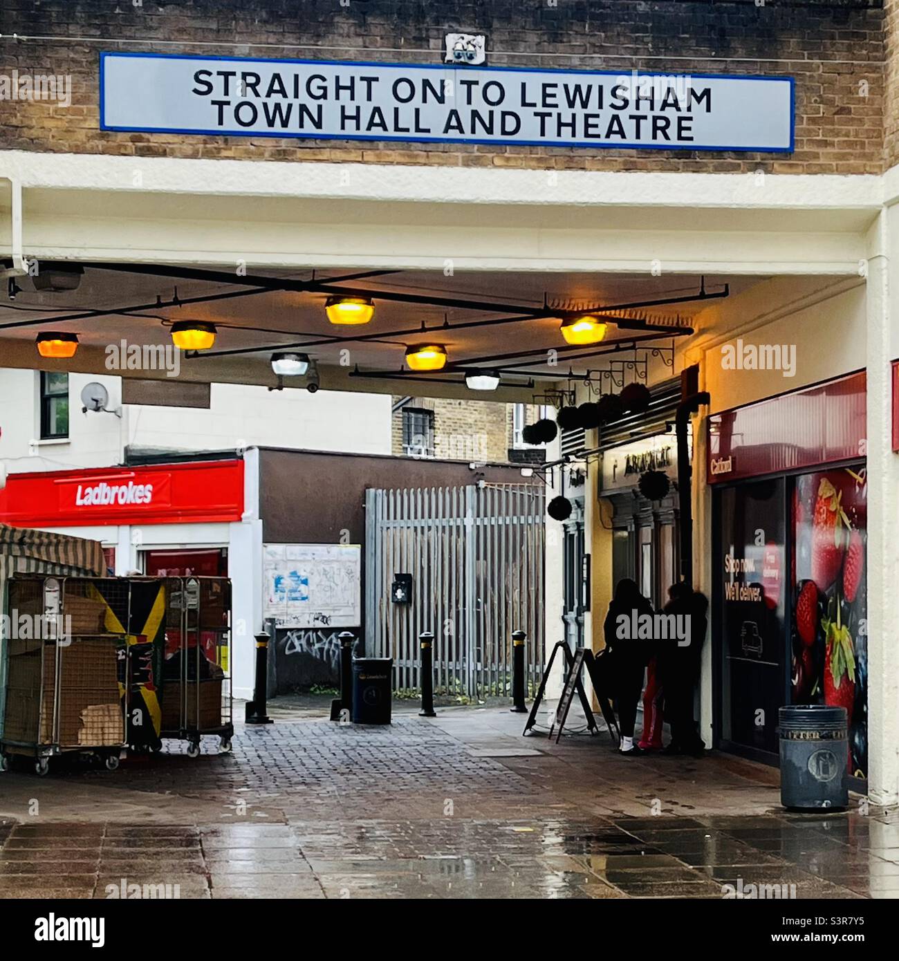 Catford Shopping Centre, sign “Straight on to Lewisham Town Hall and Theatre” - Smartphone Captured Stock Image